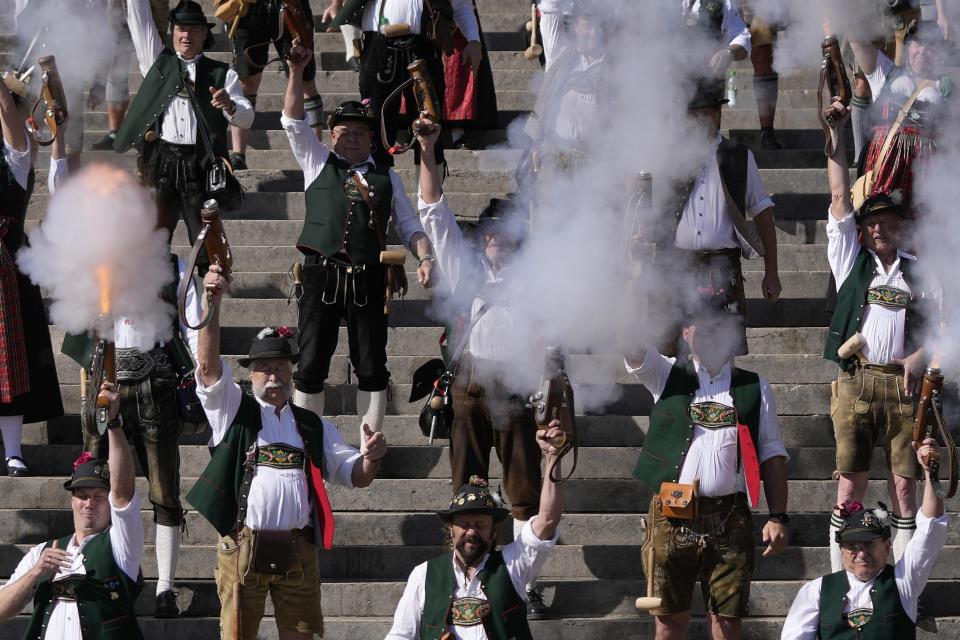 FILE - Bavarian riflemen and women in traditional costumes fire their muzzle loaders on the last day of the Oktoberfest beer festival in Munich, Germany, Tuesday, Oct. 3, 2023. The southern German state of Bavaria will ban the smoking of cannabis at public festivals, inside beer gardens, and even at the world’s most popular beer festival, the Oktoberfest. (AP Photo/Matthias Schrader, File)