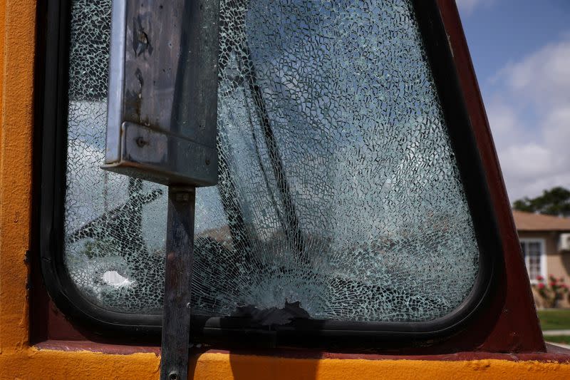 FILE PHOTO: The window of a vehicle with the "Ghetto Life" motorcycle club sits shattered with a bullet hole at the scene of a shooting in Los Angeles, California