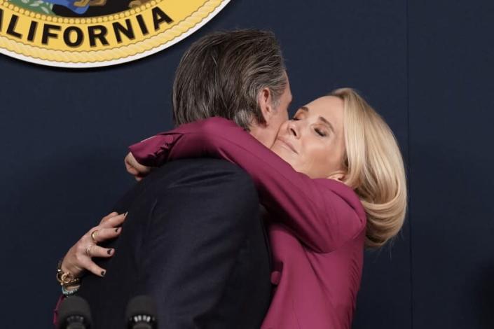 Gov. Newsom hugs his wife, Jennifer, at a news conference at which he denounced the decision to overturn Roe vs. Wade.