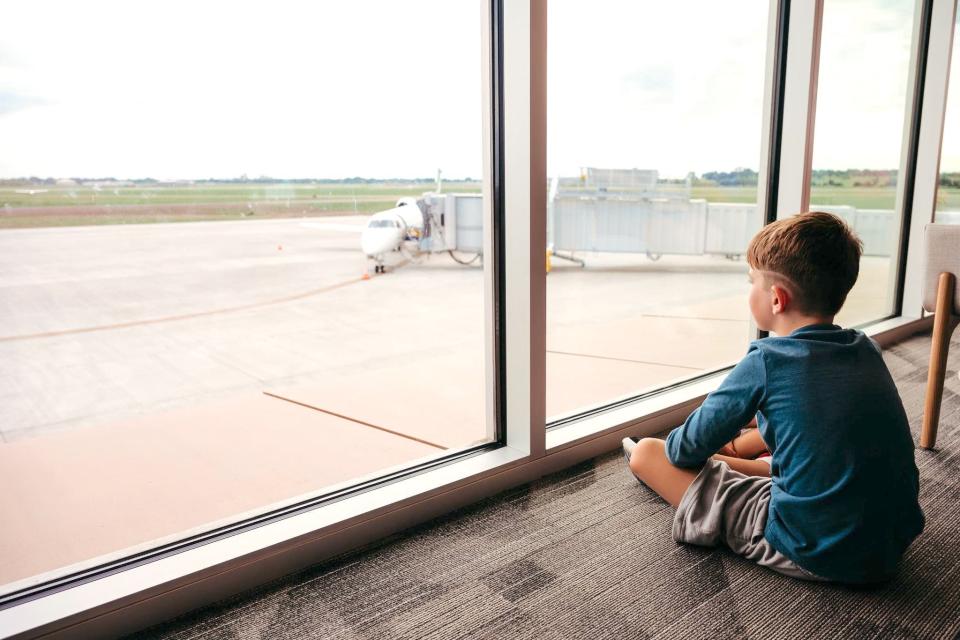 Henry Holien sits on the mezzanine observing the runway during the Kites, Flights and Bites event on Saturday.