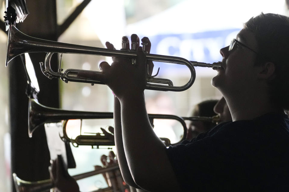 Rylan Reed, 14, plays his trumpet during the national anthem as performed by the Neshoba Central High School band, to open another day of political speeches at the Neshoba County Fair, Thursday, July 27, 2023, in Philadelphia, Miss. (AP Photo/Rogelio V. Solis)