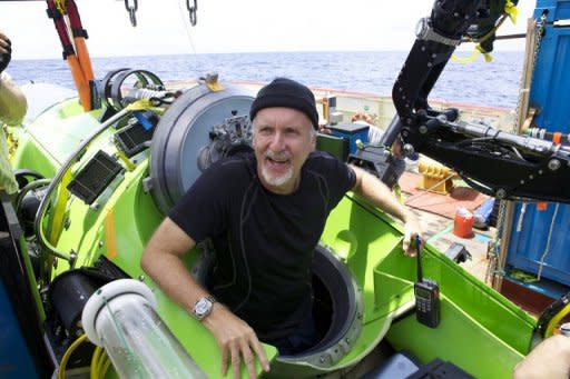 Explorer James Cameron emerges from the Deepsea Challenger submersible after his successful solo dive to the Mariana Trench, the deepest part of the ocean. Cameron described a barren "completely alien world" on the ocean floor