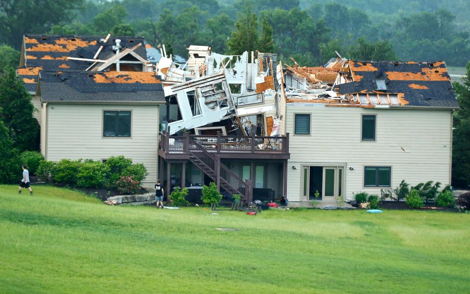 A destroyed home sits in a neighborhood after it was hit by a tornado on Tuesday, May 28, 2019, south of Lawrence, Kan., near US-59 highway and N. 1000 Road.