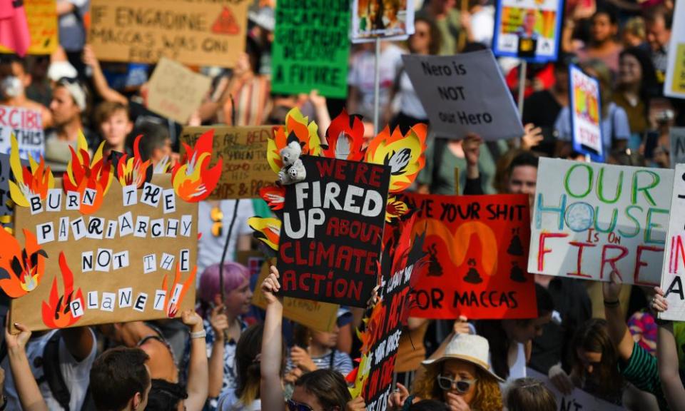 Climate change protesters hold up placards