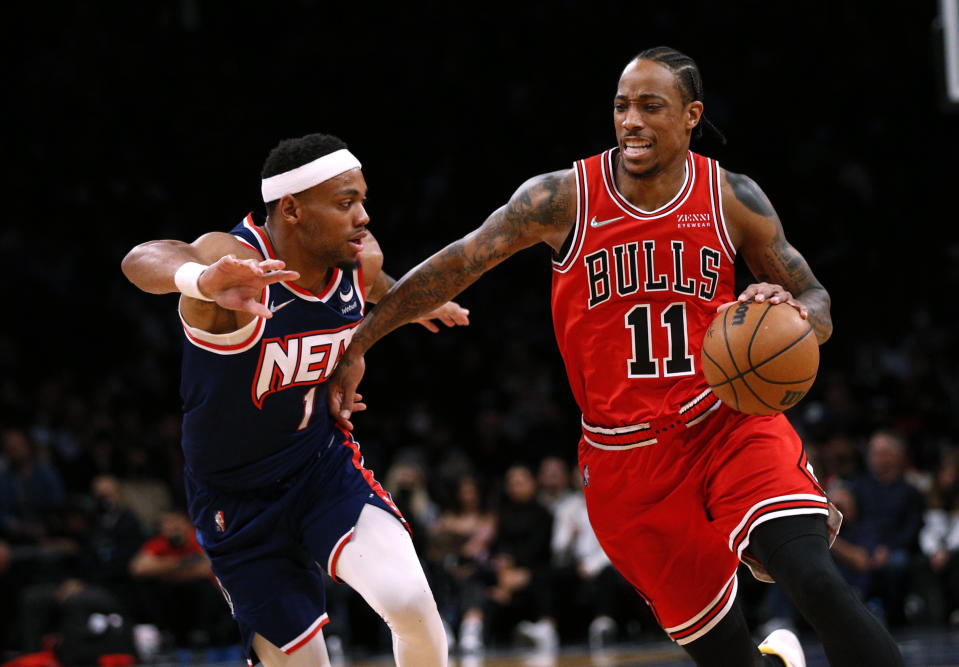 Chicago Bulls forward DeMar DeRozan (11) drives to the basket against Brooklyn Nets forward Bruce Brown (1) during the first half of an NBA basketball game in New York, Saturday, Dec. 4, 2021. (AP Photo/Noah K. Murray)