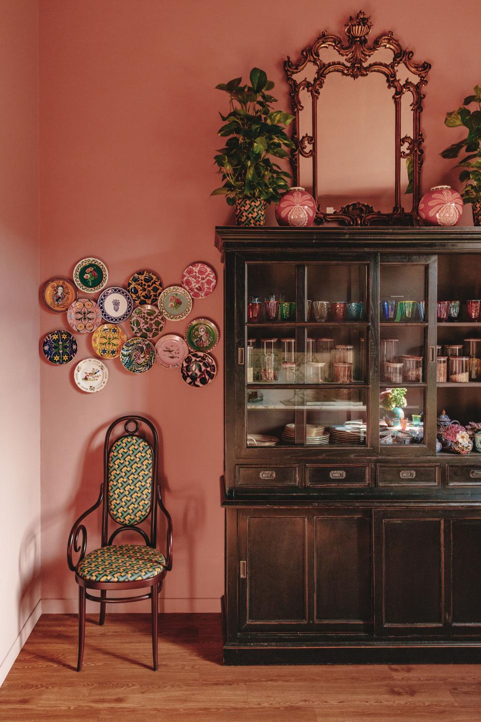 In the kitchen, La DoubleJ plates hang above a vintage Thonet chair upholstered with La DoubleJ fabric; vintage Danish cabinet.