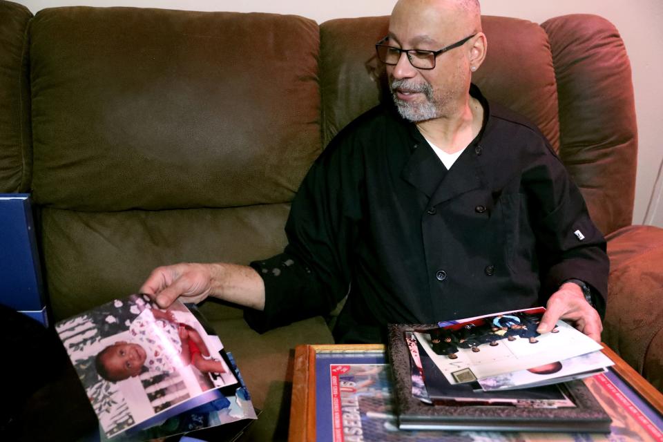 The step-father Antonio Thompson, who was close to Christopher Jones-McClean, looks through family photos of 
Jones-McClean, who was killed in the garage of his home in Murfreesboro, on Oct. 12, 2023. The family of Jones-McClean are asking the community for tips to solving the death of their loved one.