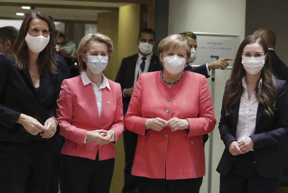 From left, Belgium's Prime Minister Sophie Wilmes, European Commission President Ursula von der Leyen, German Chancellor Angela Merkel and Finland's Prime Minister Sanna Marin pose prior to a round table meeting at an EU summit in Brussels, Friday, July 17, 2020. Leaders from 27 European Union nations meet face-to-face on Friday for the first time since February, despite the dangers of the coronavirus pandemic, to assess an overall budget and recovery package spread over seven years estimated at some 1.75 trillion to 1.85 trillion euros. (Stephanie Lecocq, Pool Photo via AP)