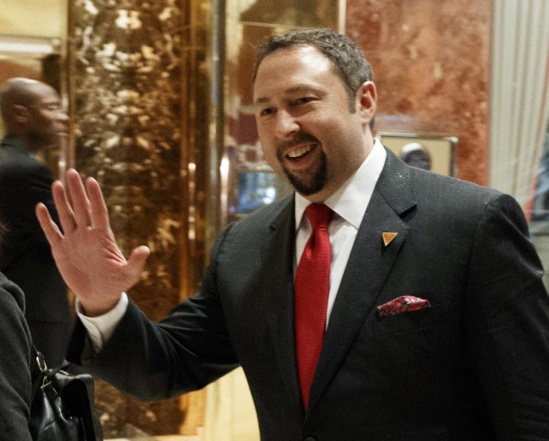 In this Nov. 29, 2016 photo, Jason Miller, Communications Director of President-elect Donald J. Trump's Transition Team, waves to reporters in the lobby of Trump Tower in New York. President-elect Donald Trump has named his senior communications team, choosing Sean Spicer as press secretary, Jason Miller as communications director, Hope Hicks as director of strategic communications and Daniel Scavino as director of Social Media. (AP Photo/Evan Vucci)