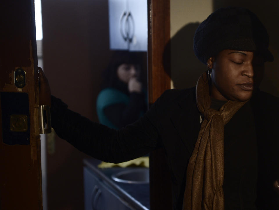 Cynthia Odigie waits for her eviction in Barcelona, Spain, Thursday, Nov. 15, 2012. The Spanish government on Thursday passed a decree suspending evictions of the most vulnerable homeowners unable to pay their mortgage, a bid to ease a trend that has seen hundreds of thousands of people lose their homes because of the brutal economic crisis. The eviction was finally suspended. (AP Photo/Manu Fernandez)