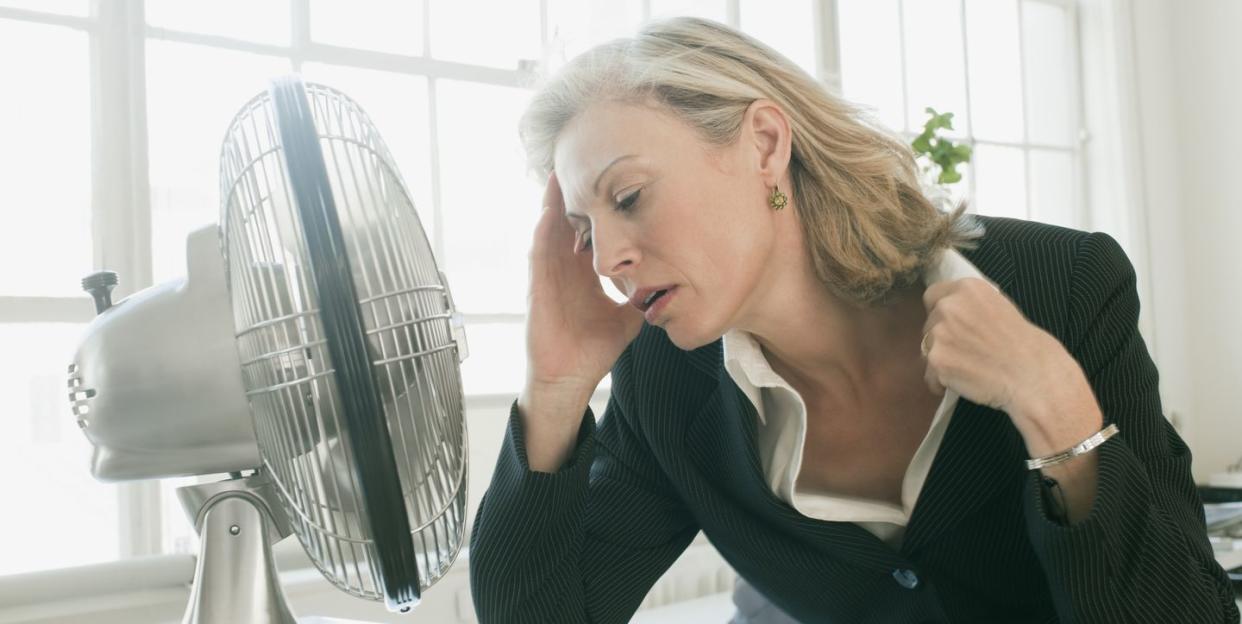 hot businesswoman sitting in front of fan