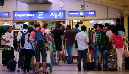 Tourists wait in the departures hall at Velana International Airport in Male, Maldives February 13, 2018. REUTERS/Stringer NO RESALES. NO ARCHIVES.
