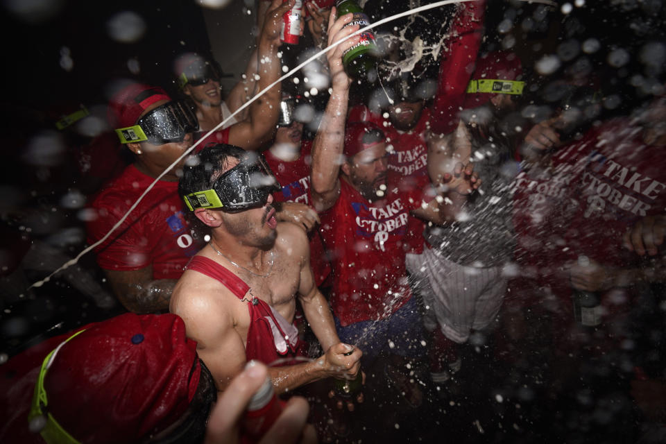 Philadelphia Phillies' Garrett Stubbs celebrates with teammates after the Phillies won an NL wild-card baseball playoff series against the Miami Marlins, Wednesday, Oct. 4, 2023, in Philadelphia. (AP Photo/Matt Slocum)