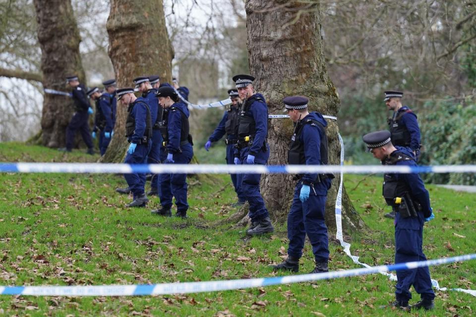 Police officers conduct a fingertip search on Primrose Hill, Camden, north London, where a teenage boy was stabbed to death (PA)