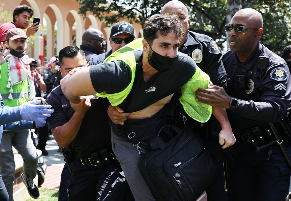 USC public safety officers detain a pro-Palestine demonstrator during clashes after officers attempted to take down an encampment (Getty Images)