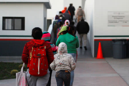 Immigrants from Central America and Mexican citizens, who are fleeing from violence and poverty, queue to cross into the U.S. to apply for asylum at the new border crossing of El Chaparral in Tijuana, Mexico, November 24, 2016. REUTERS/Jorge Duenes