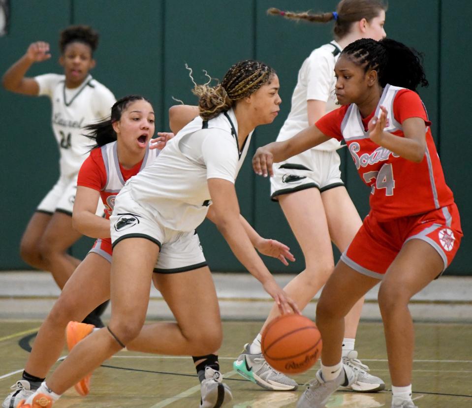 Canton South's Summer Hastings-Peterson and Madison Gordon try to contain Laurel's Saniyah Hall in the first quarter of OHSAA Division II District Semifinals at Nordonia High School. Wednesday, February 28, 2024.