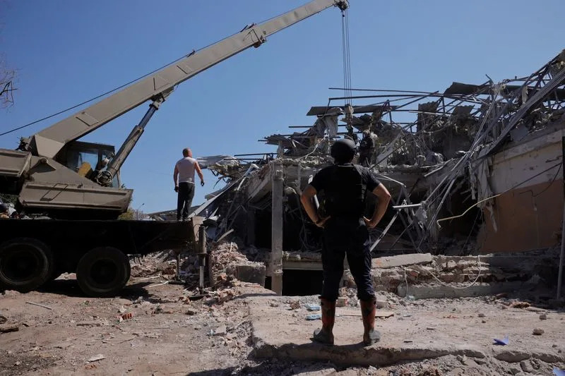 Ukrainian emergency personnel work among the rubble of a destroyed hotel following a Russian strike, in Kramatorsk