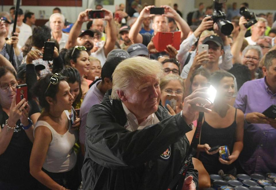 President Donald Trump takes part in a food and supply distribution at the Cavalry Chapel in Guaynabo, Puerto Rico (AFP/Getty Images)