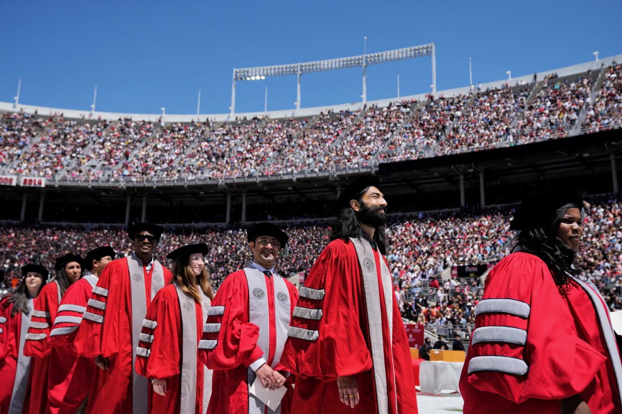 Sun., May 8, 2022, Columbus, Ohio, USA; Doctoral graduates wait to receive their hoods during Ohio State Spring Commencement at Ohio Stadium.