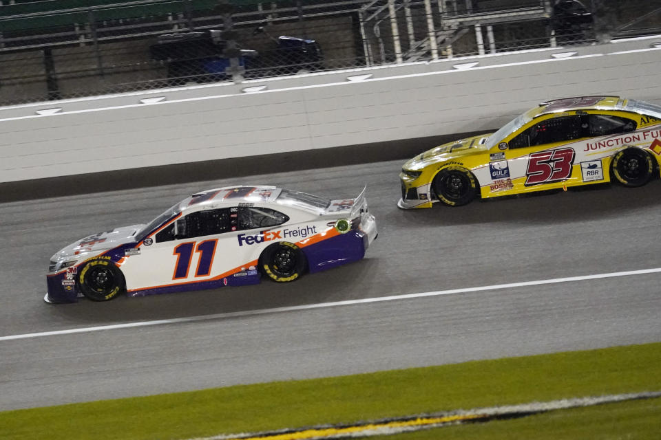 Denny Hamlin (11) battles Josh Bilicki (53) during a NASCAR Cup Series auto race at Kansas Speedway in Kansas City, Kan., Thursday, July 23, 2020. (AP Photo/Charlie Riedel)