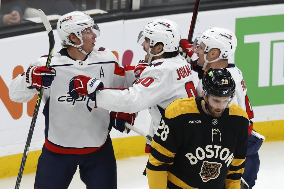 Washington Capitals' Nicklas Backstrom, left, celebrates his goal with teammates as Boston Bruins' Derek Forbort skates away during the first period of an NHL hockey game, Saturday, Feb. 11, 2023, in Boston. (AP Photo/Michael Dwyer)