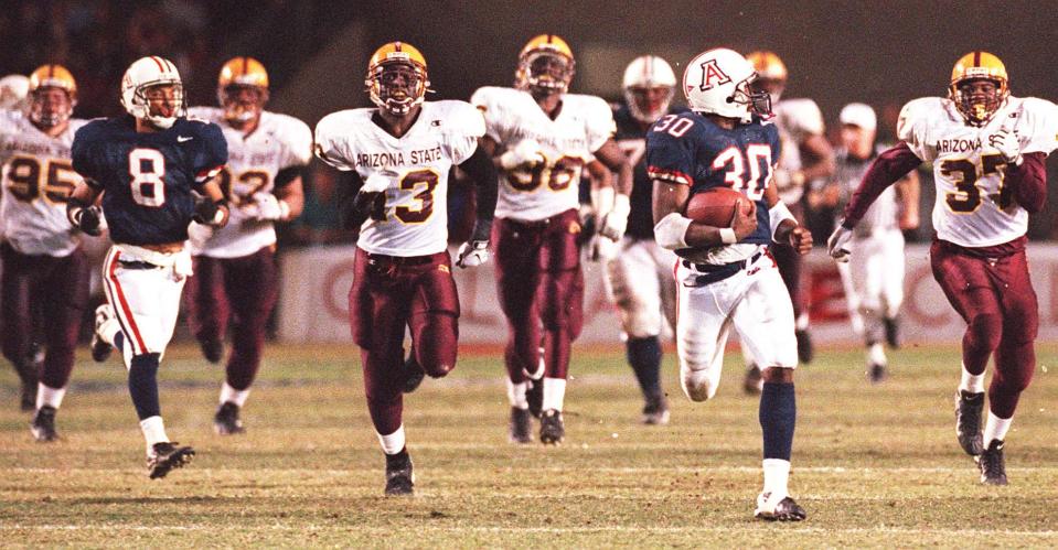 Arizona's Trung Canidate runs for his first touchdown in the first half on Nov. 27, 1998, in Tucson.