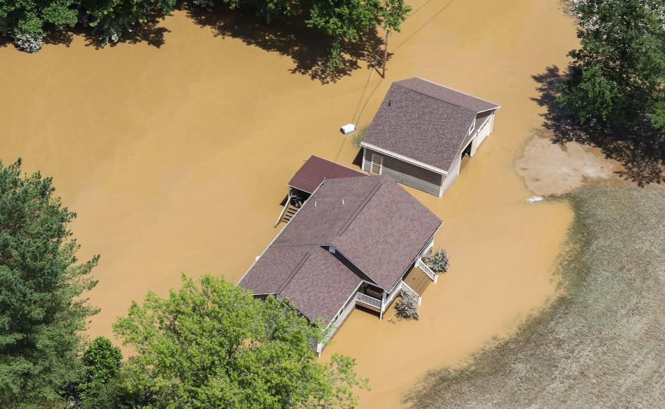 Homes in Breathitt County, Ky., sit underwater July 30 after historic rains flooded many areas of Eastern Kentucky, killing more than 20 people.