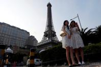 FILE PHOTO: Visitors take a selfie in front of a replica of Eiffel Tower at Parisian Macao in Macau