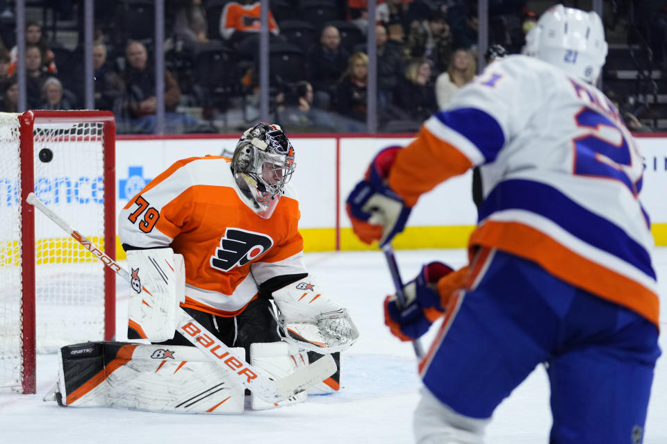 Philadelphia Flyers' Carter Hart, left, cannot stop a goal by New York Islanders' Kyle Palmieri during the first period of an NHL hockey game, Monday, Feb. 6, 2023, in Philadelphia. (AP Photo/Matt Slocum)