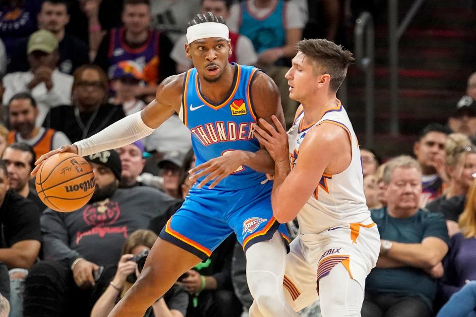 Suns guard Grayson Allen, right, defends Thunder guard Shai Gilgeous-Alexander, left, during the first half of Oklahoma City's 111-99 win Sunday night in Phoenix.