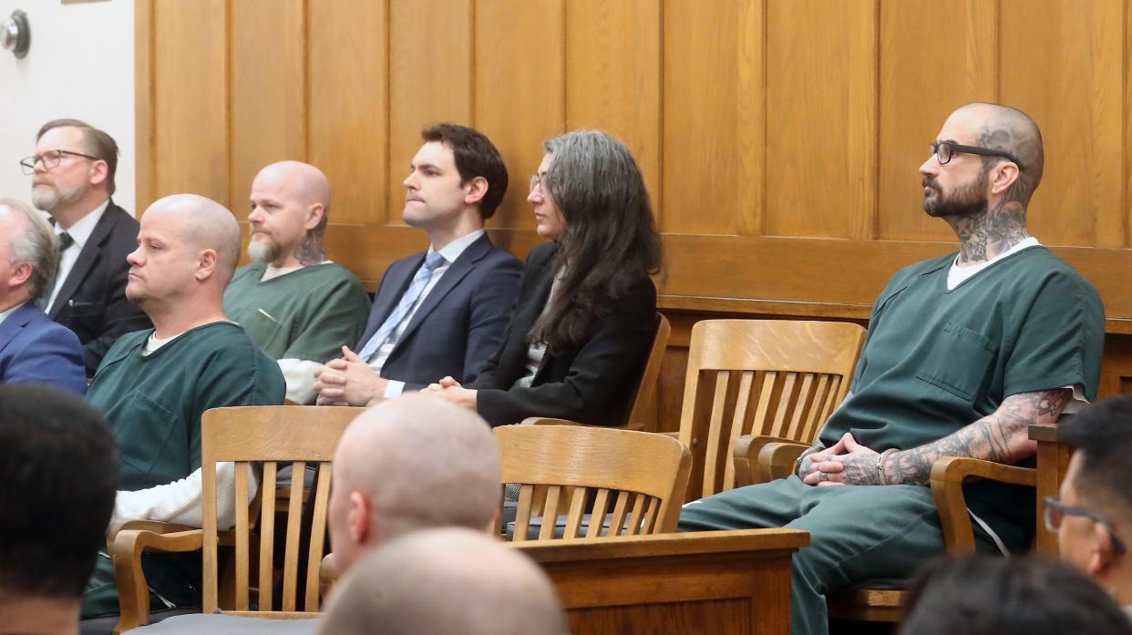 Johnny James Watson, left, Robert James Watson III, back, and Danie Kelly Jr., right, sit with their attorneys during their sentencing hearing on Tuesday in Port Orchard. Superior Court Judge Kevin Hull sentenced each man to four life sentences for each murder they were convicted of in April, as well as some additional charges.