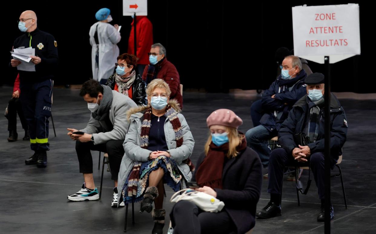 People, wearing protective face masks, wait for their test results at a coronavirus disease (COVID-19) testing center installed inside in the Kursaal concert hall in Dunkirk, France - PASCAL ROSSIGNOL /REUTERS