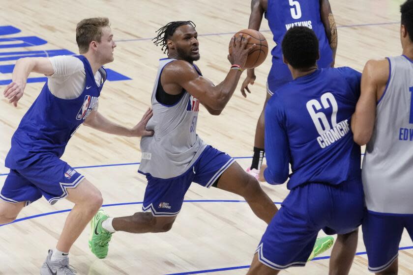 Bronny James (50), second from left, drives to the basket past Cam Spencer, left, during the 2024 NBA Basketball Draft Combine in Chicago, Tuesday, May 14, 2024. (AP Photo /Nam Y. Huh)