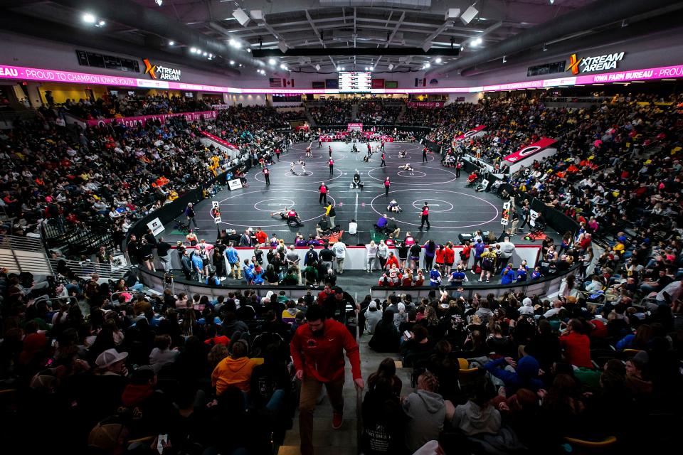 A general view as fans watch wrestlers compete on eight mats during the IGHSAU state girls wrestling tournament, Thursday, Feb. 2, 2023, at the Xtream Arena in Coralville, Iowa.