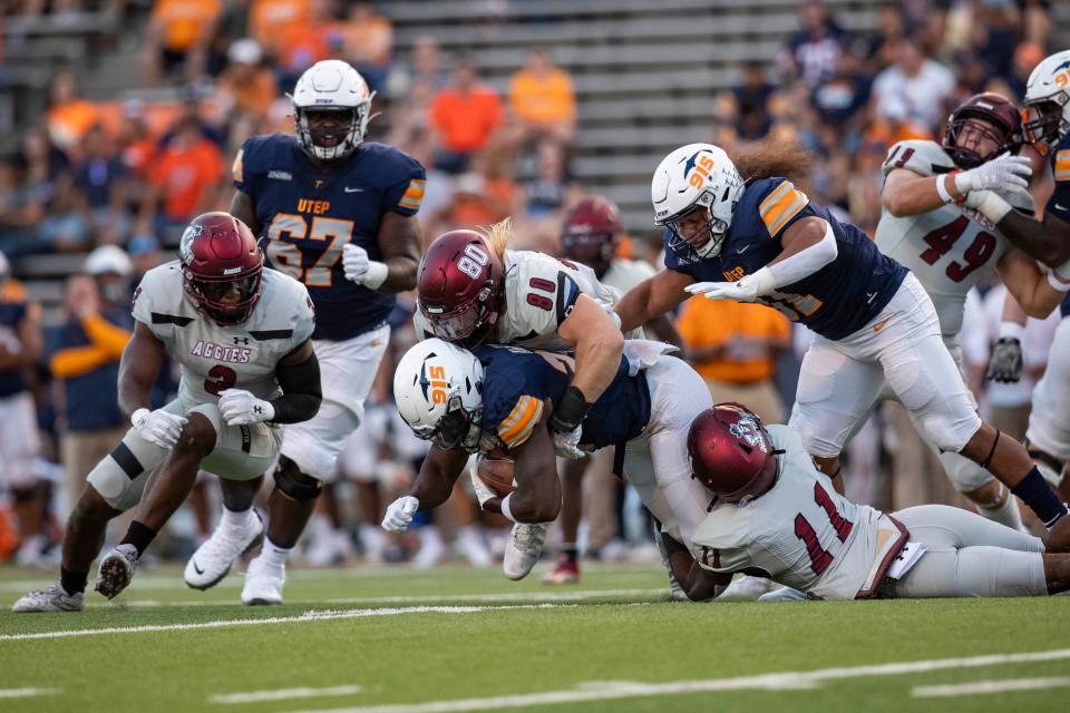 NMSU linebacker Trevor Brohard tackles an UTEP player during the Aggies football game on Saturday, Sept. 10, 2022, at the Sun Bowl. 