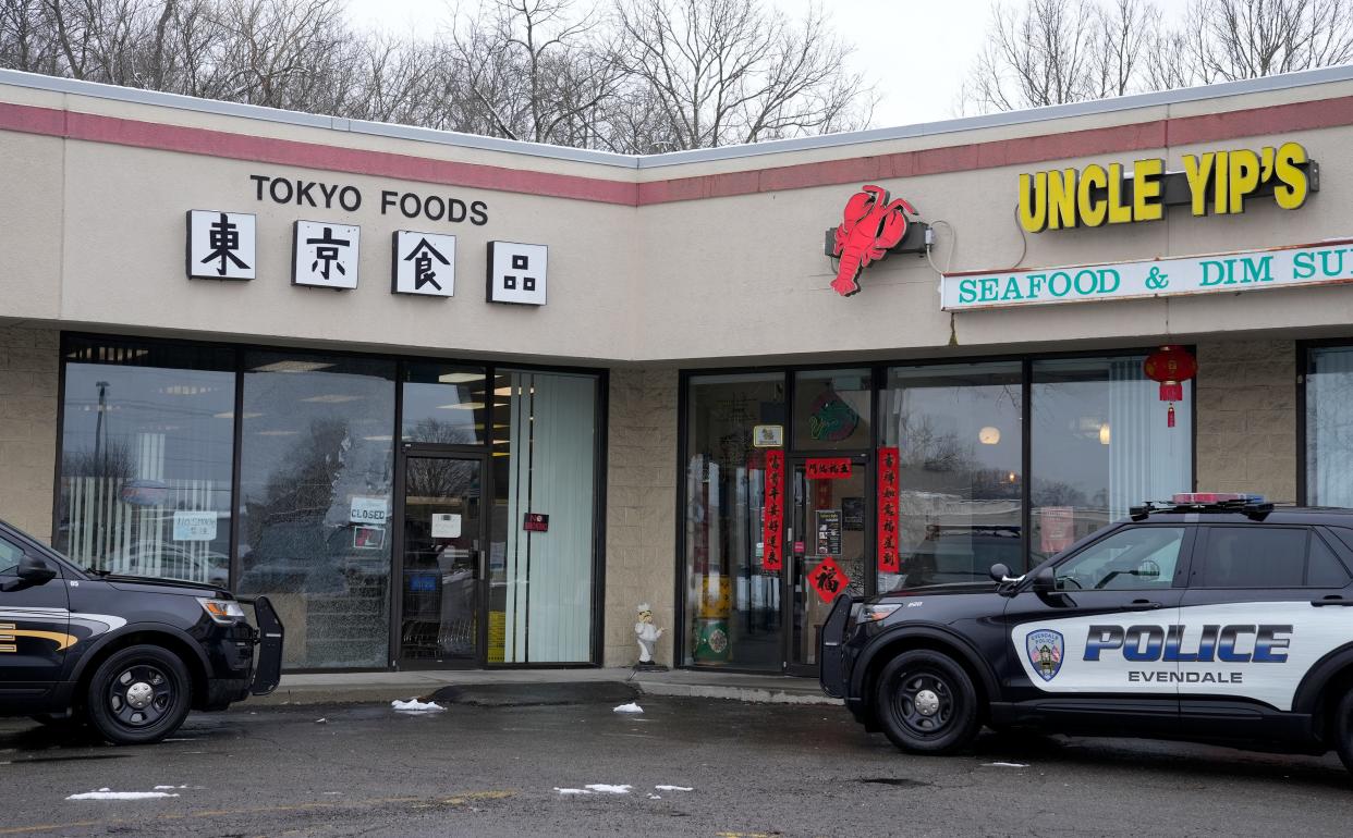 Evendale Police sit outside Tokyo Foods and Uncle Yip's seafood restuarant on Monday, January 23, 2023, a day after a man was arrested after police say he fired several shots into the grocery store. Nine people were inside Uncle Yip's at the time.