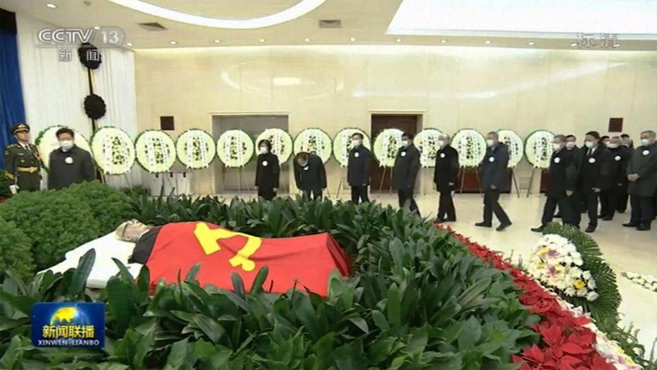 In this image taken from video footage run by China's CCTV, Chinese leaders bow to remain of former president Jiang Zemin before sent for cremation at Babaoshan cemetery, at a military hospital in Beijing, Monday, Dec. 5, 2022. Chinese President Xi Jinping and other current and previous top officials paid their respects Monday to former leader Jiang Zemin, who died last week at age 96. (CCTV via AP)