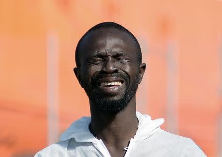 A migrant cries after disembarking from SOS Mediterranee ship Aquarius in the Sicilian harbour of Trapani, southern Italy, July 22, 2016. REUTERS/Guglielmo Mangiapane