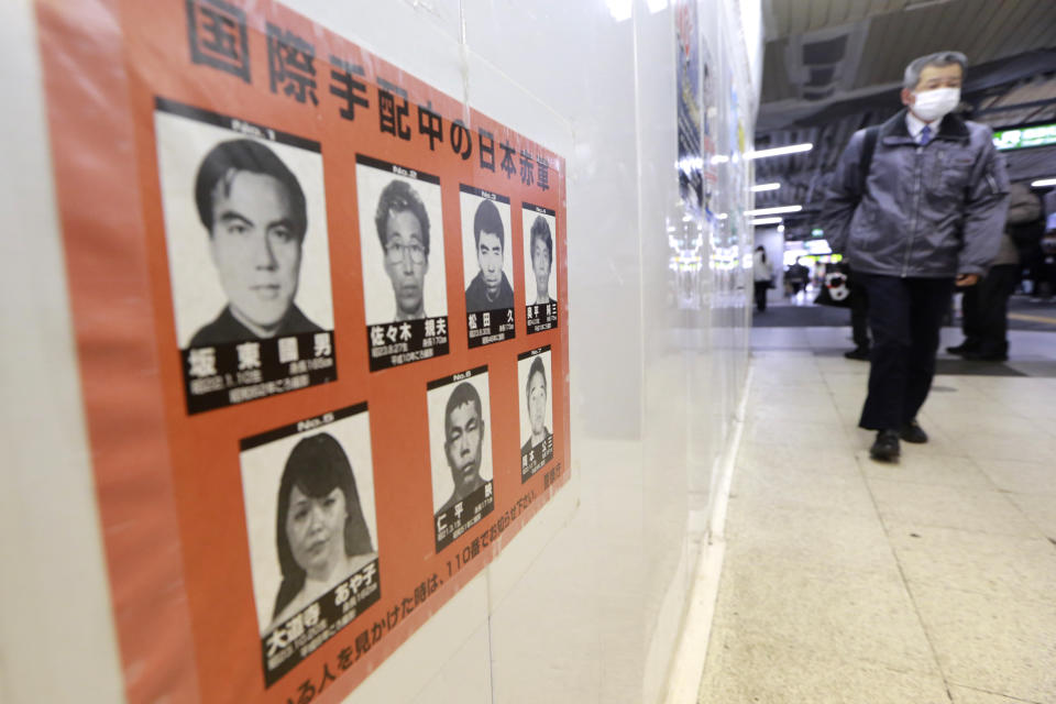 A poster of wanted Japanese terrorists is seen in Tokyo, Tuesday, Feb. 15, 2022. Tokyo police on Monday stepped up the hunt for members of the Japanese Red Army wanted for their alleged role in attacks in the 1970s and 1980s, releasing a video with images of the aging militants that warned the “case” was not over yet. (AP Photo/Koji Sasahara)