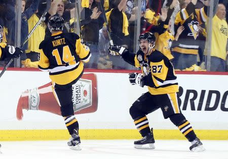 May 25, 2017; Pittsburgh, PA, USA; Pittsburgh Penguins left wing Chris Kunitz (14) and center Sidney Crosby (87) react after Kunitz scored a goal in double overtime against the Ottawa Senators to win game seven of the Eastern Conference Final of the 2017 Stanley Cup Playoffs at the PPG PAINTS Arena. Mandatory Credit: Charles LeClaire-USA TODAY Sports