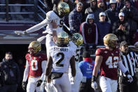 Wake Forest wide receiver A.T. Perry (9) is lifted by teammate Michael Jurgens (55) after scoring a touchdown as Boston College linebacker Vinny DePalma (42) looks away in the first half of an NCAA college football game, Saturday, Nov. 27, 2021, in Boston. (AP Photo/Mary Schwalm)