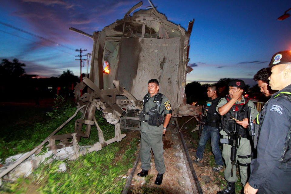 Military personnel inspect the site of a bomb attack at Khok Pho district