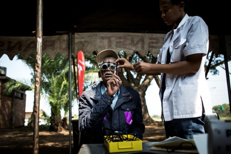 A man getting his eyes tested outside the Phelophepa train, whose services include low-cost glasses