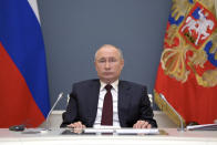 Russian President Vladimir Putin prepares to attend the virtual Leaders Summit on Climate in Moscow, Russia, Thursday, April 22, 2021. (Alexei Druzhinin, Sputnik, Kremlin Pool Photo via AP)