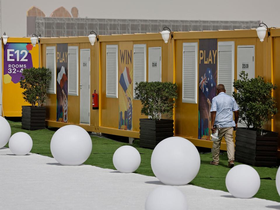 Doha, Qatar - November 9, 2022 A worker walks past cabins at the Fan Village Cabins Free Zone ahead of the World Cup