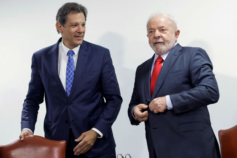 FILE PHOTO: Brazil's Economy Minister Fernando Haddad greets President Luiz Inacio Lula da Silva during a meeting to sign the government's economic package at the Planalto Palace in Brasilia