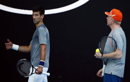 Serbia's Novak Djokovic talks with his coach Boris Becker (R) during a practice session at Melbourne Park, Australia, in this January 17, 2016 file photo. REUTERS/Thomas Peter
