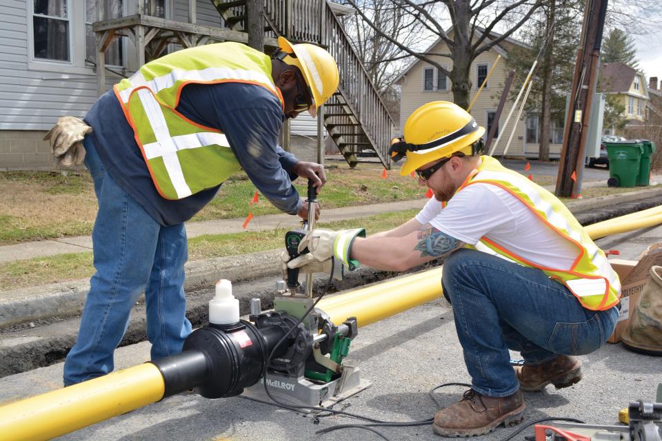 Central Hudson workers using a device that fuses pipe during replacement work on Oakwood Boulevard in the city of Poughkeepsie.