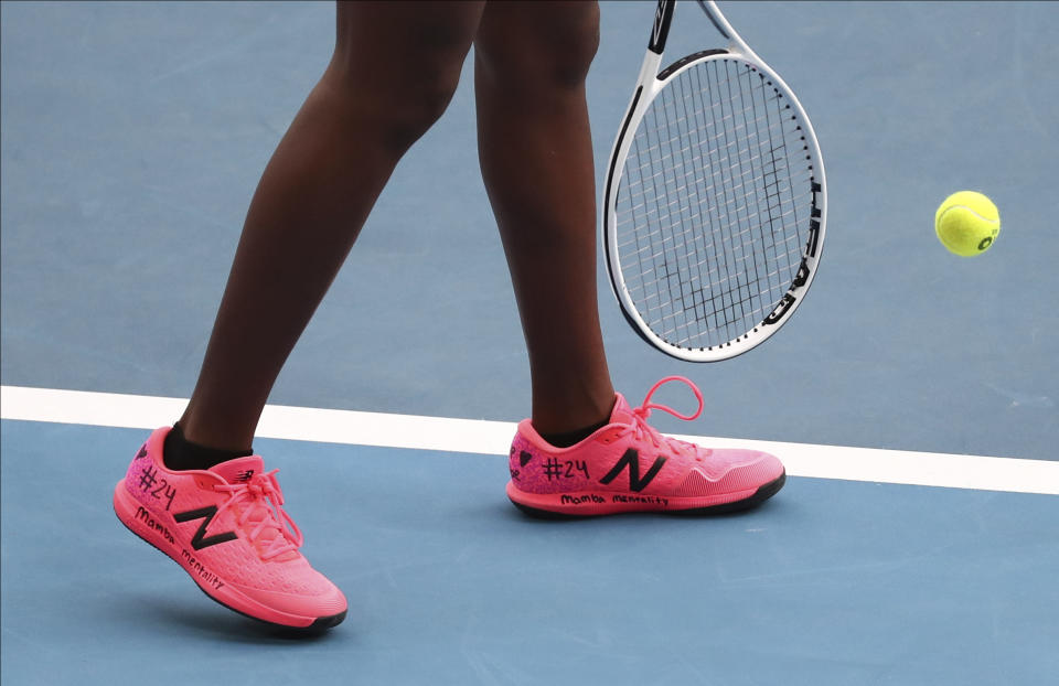 United States' Coco Gauff, shown with a tribute to Kobe Bryant written on her shoes as she prepares to serve during her doubles match with compatriot Caty McNally against Japan's Shuko Aoyama amd Ena Shibahara at the Australian Open tennis championship in Melbourne, Australia, Monday, Jan. 27, 2020. (AP Photo/Dita Alangkara)